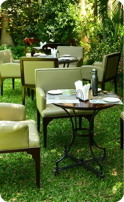 Outdoor garden dining setup at Bustani Tulivu resort