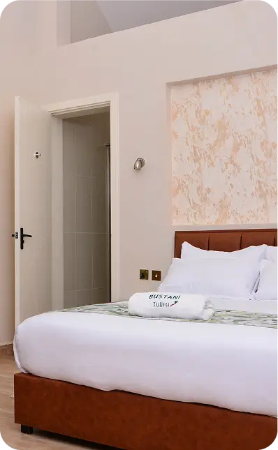 Comfortable bed in cottage room at Bustani Tulivu Bungoma